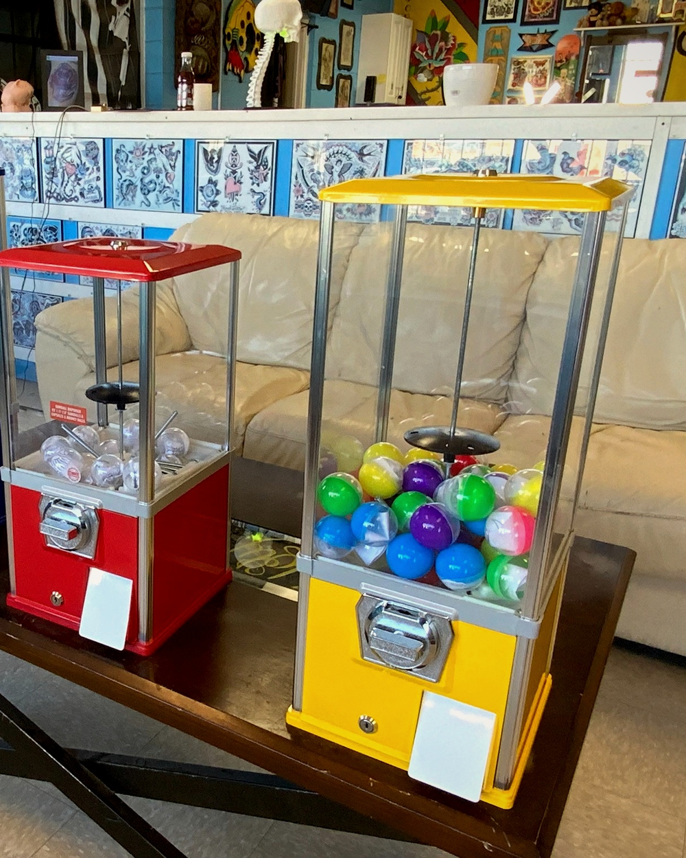 Colorful capsule prize machines on a table in the Holy Grail lounge
