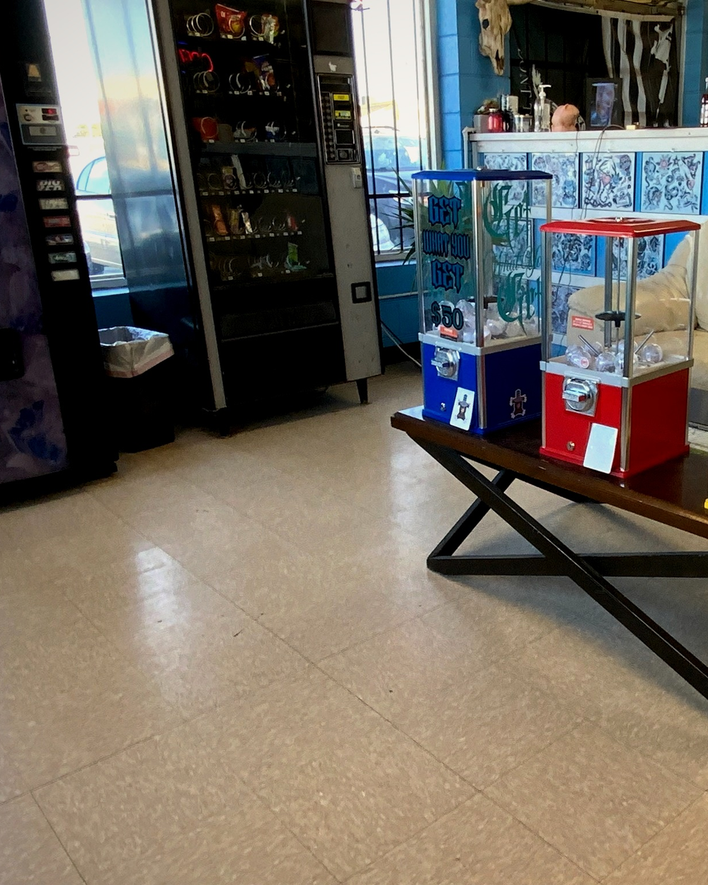 A wider view of the prize machines beside the waiting-area couch