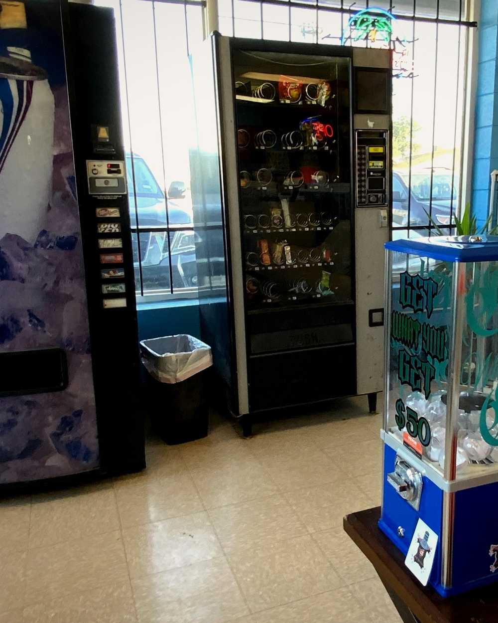 Vending and capsule machines near the flash-lined front counter