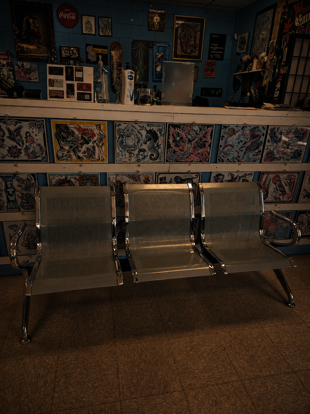 The chrome waiting bench set against a full wall of traditional flash designs